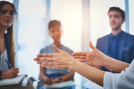 Shes carefully explaining her new idea to the team. Closeup shot of an unrecognzable businesswomans...