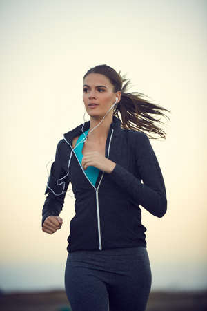 Nothing clears your head better than a good run. a sporty young woman exercising outdoors.