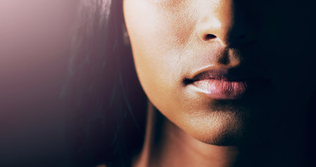 Enough talking. Closeup shot of a young womans beautiful lips against a dark background.の写真素材