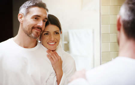 Lets get the morning started on a fresh note. a mature couple taking getting ready in the bathroom at home.の写真素材