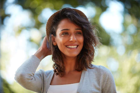 The outdoors are my favorite. Portrait of a beautiful young woman spending the day outdoors on a...