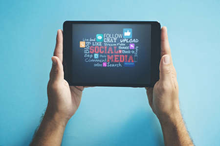 Hands of a person browsing social media on a tablet screen, checking notifications and reading messages online on the web. Closeup of a man searching the internet and staying connected with techの写真素材