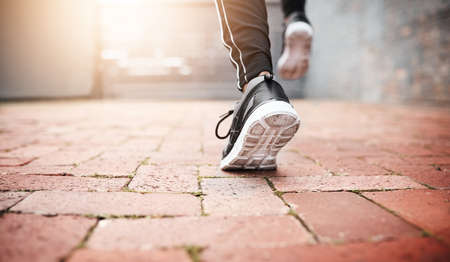 Dont stop until you cross that line. Closeup shot of an unrecognizable woman exercising outdoors.