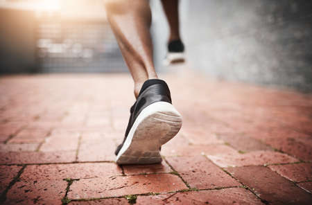 Run your heart out. Closeup shot of an unrecognizable man exercising outdoors.