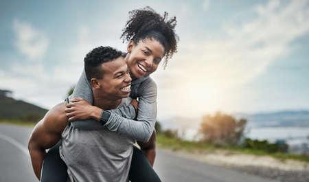 Youve gotta have a partner you can rely on. a handsome young sportsman piggybacking his athletic young girlfriend outside.の写真素材