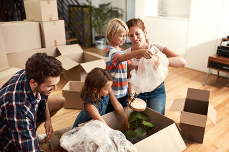 Turning the page to a new home. a young family on their moving day.の写真素材