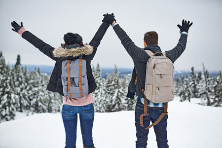 Set yourself free. a happy young couple enjoying themselves while being out in the snow.の写真素材