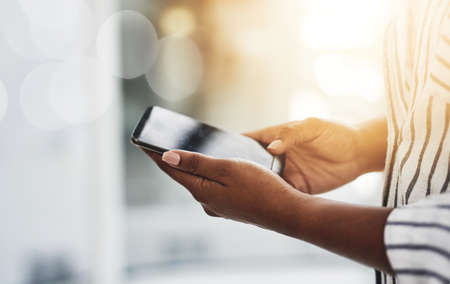 Closeup of female hands chatting or typing a text message to a friend on social media on a phone....