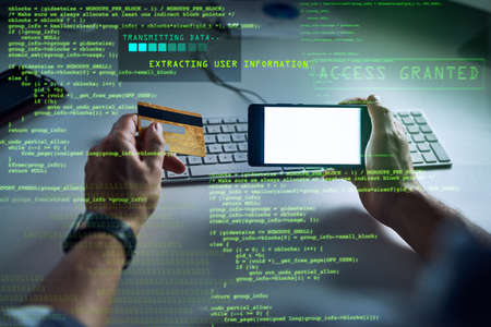 Hacker hacking, committing fraud or financial theft with bank credit card information technology and...
