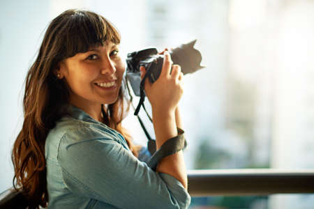 Capturing the beauty around me. a woman taking pictures with her camera outside.