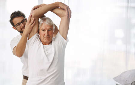Your mobility seems good. a young male physiotherapist working with a senior male patient.