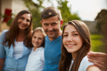 Family means the world to me. Cropped portrait of a young family of four standing outside.