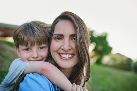Mommy will always be around to care and protect him. Portrait of a mother bonding with her little son outdoors.の写真素材