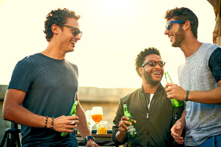 Friends dont let friends have fun alone. a group of young friends hanging out and having drinks...