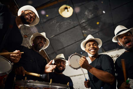 Its carnival time. Portrait of a group of musical performers playing drums together.の写真素材