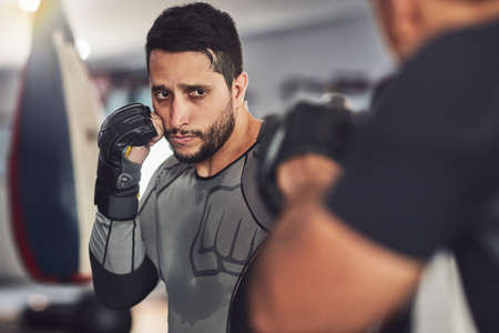 Striking the first blow. two professional fighters sparring in the gym.の写真素材