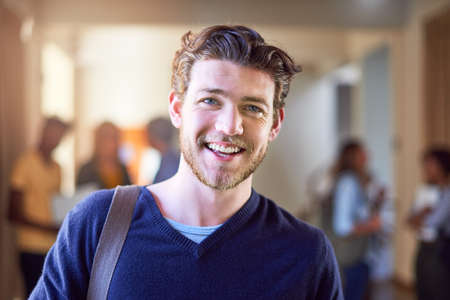 Im doing it for my future. Portrait of a university student standing in a corridor at campus.