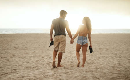 Summer, the season of romance. a young couple spending a romantic day at the beach.の写真素材