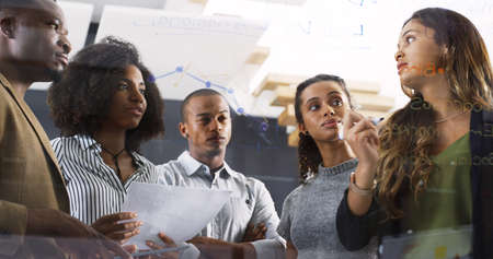 How can we improve these stats. a diverse group of businesspeople brainstorming on a glass wall in a...