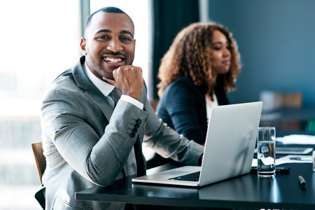 Ive learnt a lot so far... Cropped portrait of a handsome young businessman working on his laptop...