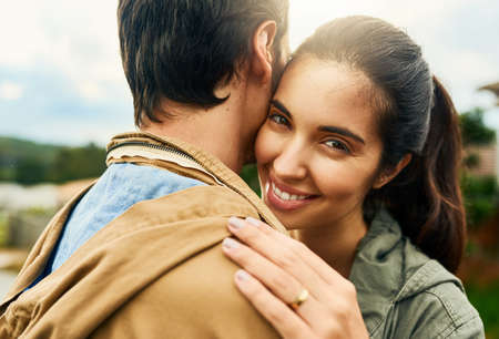 Falling for him was easy. an affectionate young couple standing outdoors.