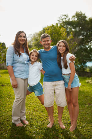 Theyre a picture book family. Full length portrait of a young family of four standing outside.
