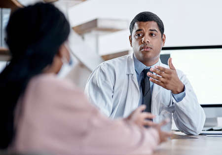 Doctor talking to patient in medical consultation, checkup and consult in clinic, hospital and...