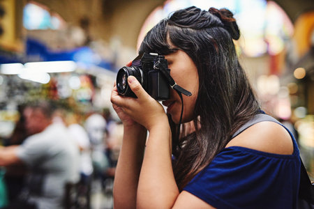 I want to take photos non stop of this market. a carefree young woman taking photos of a food market...
