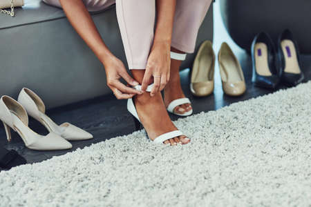 Shoes glorious shoes, Id like to wear you. an unrecognizable woman trying on shoes while on a shopping spree in a boutique.の写真素材