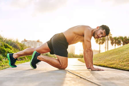 Steeping up his fitness game. Portrait of a handsome young man exercising outdoors.