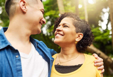I could get lost in those eyes. an affectionate young couple standing face to face outside in the...