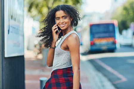 When travelling in the city, always carry a cellphone. an attractive young woman on a call in the...