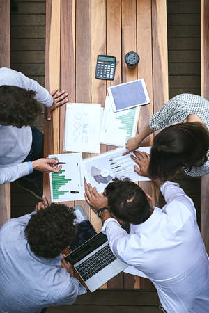 Together we will improve these stats. High angle shot of a team of businesspeople having a meeting...