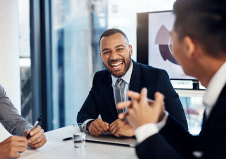 Not all meetings are stiff and starchy. a group of young businesspeople having a meeting in the...