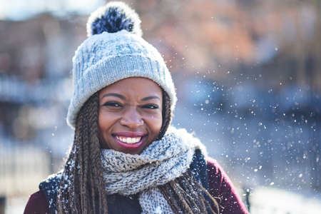 Goodby autumn, hello winter. Portrait of a beautiful young woman enjoying a wintery day outdoors.の写真素材