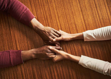 Youre never alone. Closeup shot of two unrecognizable people holding hands in comfort.