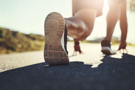 Lets do this, Im ready. Rearview shot of an unrecognizable man getting ready to run outdoors.