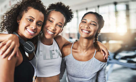 Everyone needs a supportive friend on their side. a group of happy young women enjoying their time together at the gym.の写真素材
