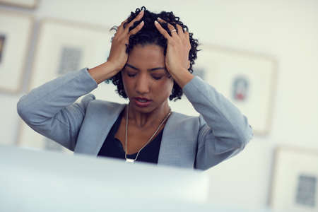 This cant be happening right now. a young businesswoman in the office.の写真素材