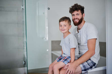 Time to get fresh and ready for the day. Portrait of a father and his little son getting ready in the bathroom at home.の写真素材