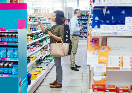 This should help with that cough. a female customer in a pharmacy.の写真素材