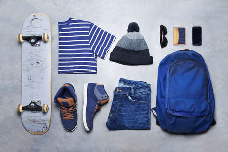 Skater boy outfit, style or fashion laid out on the floor looking edgy, trendy and fashionable with...