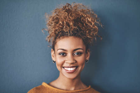 Face of a happy, confident and beautiful black woman with a positive mindset a bright smile....
