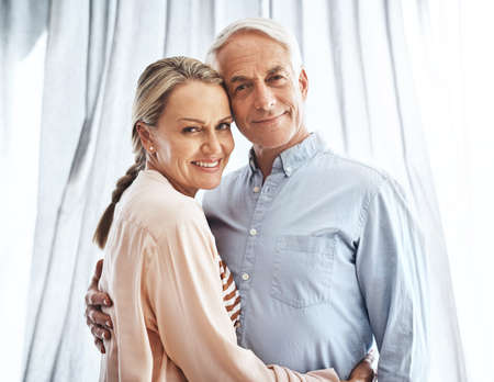 Our life together has been a happy one. Cropped portrait of an affectionate mature couple in their home.の写真素材