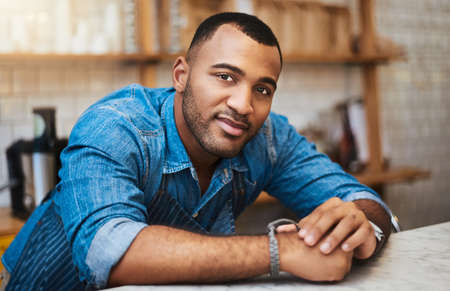 You can treat this place like home. Cropped portrait of a handsome young man standing in his coffee...