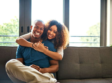 Our love for each other keeps growing each day. Portrait of a happy young couple relaxing together...