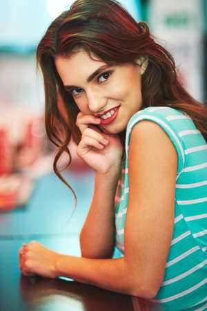 Would you like to join her. a beautiful young woman in a diner.