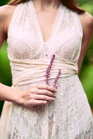 How she loves the delicate plants. an unrecognizable woman holding a flower posing in nature.の写真素材