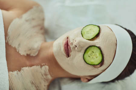 Slipping into a soothing day. an attractive young woman relaxing on a massage bed at a beauty spa.の写真素材