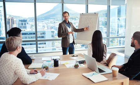 The goal is to capitalise on all our small markets. a businessman giving a presentation to his...